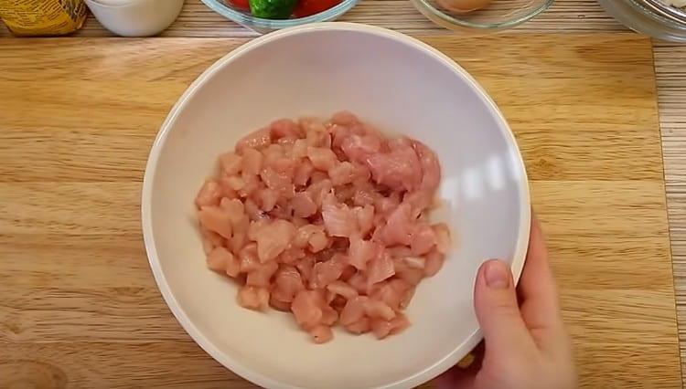 Разстелете нарязаното пиле в дълбока купа.