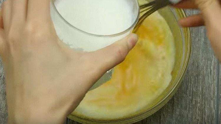 Добавете мляко към яйчената маса.