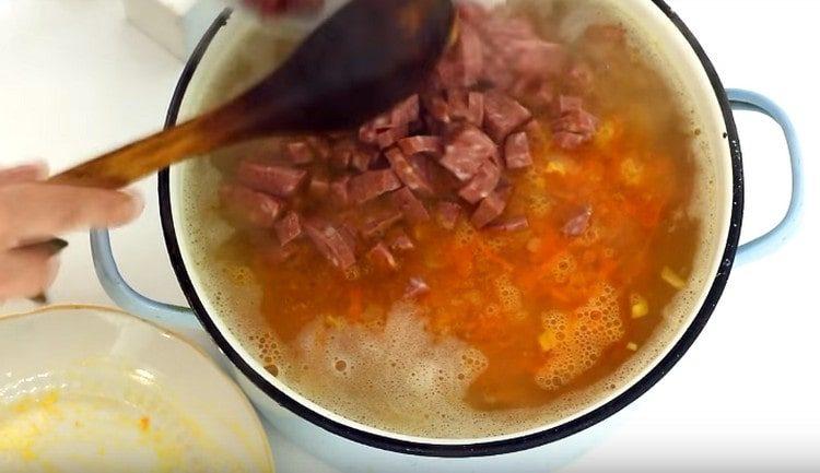 Разстиламе наденица в тенджера със супа.